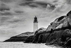 Moose Peak Light Tower Over Rocky Shore in Maine -BW